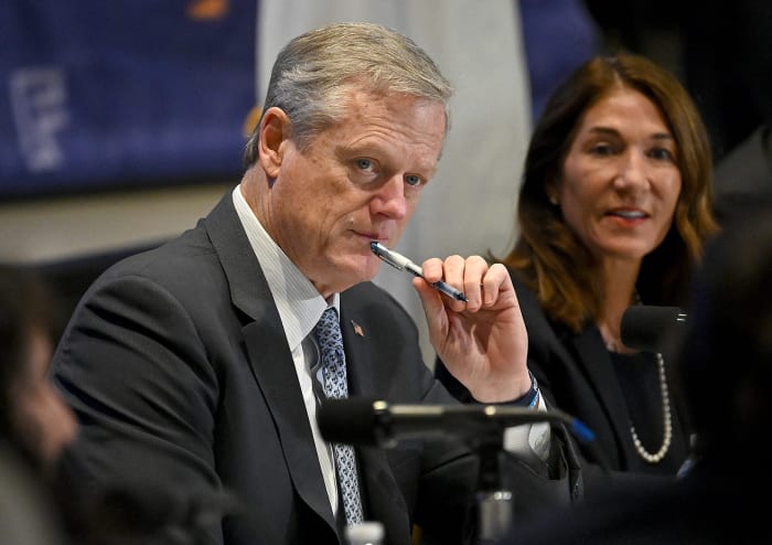 Charlie Baker listens to a presentation.
